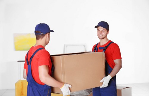 Removal van and moving crew in a West London residential street
