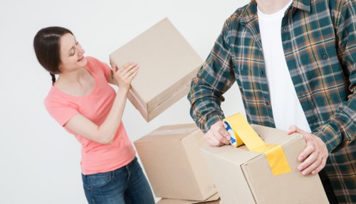 Packed moving boxes and furniture ready for transport in West London