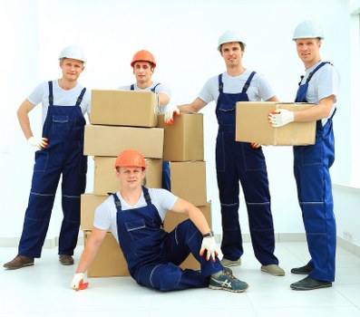 Removal team loading furniture for a West London house move