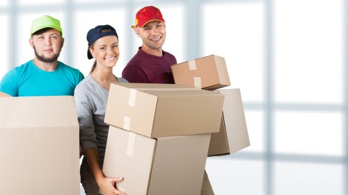 Professional movers handling office relocation items carefully