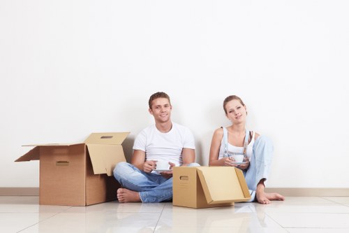Removal team delivering boxes and furniture to a West London property