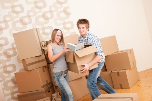 Professional moving team handling boxes and furniture for a local removals job