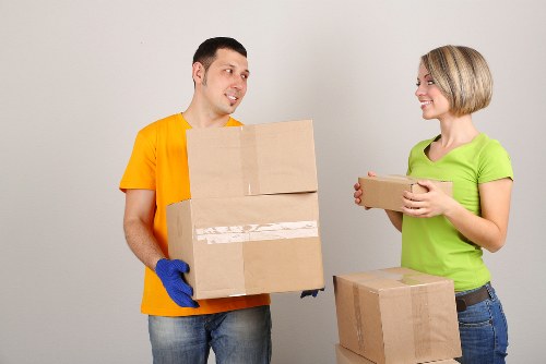 Professional removals service handling packed boxes with care